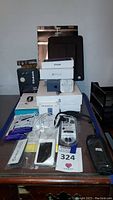 Overview of all electronics and accessories on desk including boxes, cables and cases