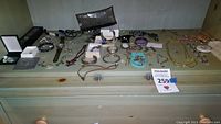 Wood dresser shelf with assorted jewelry and watches