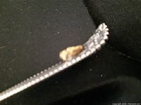 Close-up of spoon handle showing gold nugget and beaded edge detail.