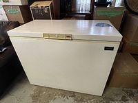 Closed front view of white Kenmore chest freezer with control panel and brand label visible.