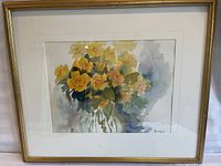 Front view of framed watercolour painting of yellow roses signed by J. Fick.