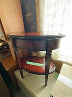 Side view of the wooden side table showing drawer and bottom shelf.