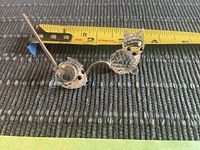 Side view of Swarovski cat and mouse figurines next to a measuring tape showing cat about 1.5 inches tall