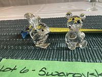 Crystal squirrel and bear figurines with a tape measure showing approximately 2 inches height.