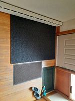 All three mats laid out on wooden floor viewed from above, showing size and color differences.