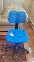 Blue plastic adjustable task chair with perforated seat and back, black plastic base with five wheels shown from front angle