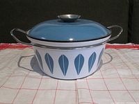 Blue and white Cathrineholm handled casserole with lid on, showing side profile.