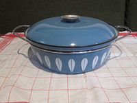 Front view of blue Cathrineholm casserole with white lotus petal pattern, lid on, showing overall design and condition.