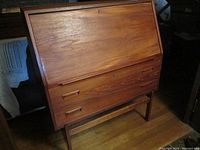 Front view of closed drop front desk showing overall design and condition