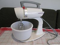 Front right angled view of Dormeyer Mix Maid stand mixer with mixing bowl attached on a cloth surface