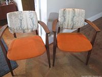 Front view of both chairs side by side on hardwood floor