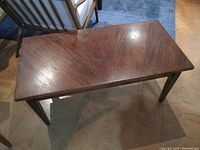 Top surface view showing the diagonal grain pattern and some marks on the wood.