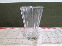 Front view of clear glass vase showing vertical fluted pattern and solid base.