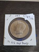Obverse of 1983 U.S. half dollar coin showing John F. Kennedy's profile and date 1983.