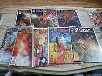 Nine Starman comic books laid out on table showing front covers, numbered 1 through 9, with colorful illustrative comic art and characters on each cover.