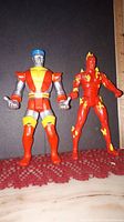 Front view of Colossus and Human Torch Marvel action figures posed standing upright next to a ruler for size reference.