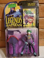 The Legends of Batman The Joker action figure in original packaging featuring The Joker figure and two accessories with DC Comics branding and price sticker.