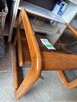 Close-up angle showing the rounded wooden frame and clear glass top inset in the wood table.