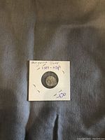 Ancient Hungarian Dinar coin displayed in a protective flip showing obverse side with detailed engravings.