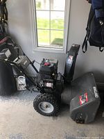 Side view showing overall unit, engine and control handles