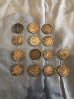 14 Canadian large pennies arranged in rows showing reverse sides with 'ONE CENT' and wreath design.