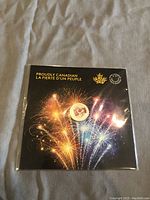 Front of the packaging showing coin display with fireworks design and bilingual text.