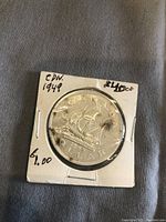 1949 silver dollar coin showing the sailing ship reverse side.