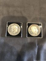 Obverse faces of both 1971-S Silver Proof Ike Dollar coins showing Eisenhower profiles in capsules.