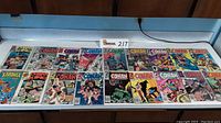Wide view of 20 vintage Marvel comic books laid out on a table, including Conan The King, Conan The Barbarian, and Dr Strange.