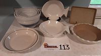 Photo showing the full set of mixing bowls, pie plates, baking tray, and fish dishes arranged, highlighting their shapes and sizes.