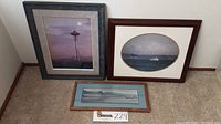 Three framed photographs including James Nielsen's Space Needle and Mt Rainier, and Ron Keebler's Cannon Beach.