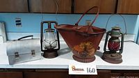 Photo showing all four items together: aluminum lunchbox, Dietz lantern, painted coal bucket with mushroom design, Embury No. 350 lantern