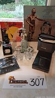Photo showing vintage Mattel 'Barbie Sings' 45 rpm records (3) including 'Barbie Sings' and 'The Story of Starwars' 1977 original soundtrack, Lenox Disney crystal figurines, Waterpik, Timex Expedition watch in box, and Swissklip clippers box.