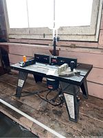 Ryobi router installed under table, view of table top with fence and push block