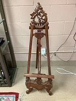 Full view of the carved wooden display easel showing its overall design and structure.