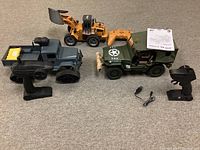 Lot shows three remote control vehicles: a green military jeep with a soldier figure, orange bulldozer, and gray military truck with tracks. Each vehicle has its own remote controller visible.