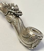 Close-up image showing the dragon's head detail and patterned bowl rim.