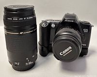 Front view showing Canon EOS 500 body with 35–80mm lens mounted and 75–300mm lens standing beside it