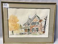 Front view of framed signed watercolour of a Victorian-style house with autumn trees, showing minor wear on the frame and reflection on glass.