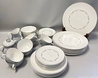 Full set arranged showing serving plate, plates of various sizes, cups, saucers, sugar bowl, creamer.