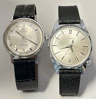 Two vintage wristwatches side-by-side: Candino Naval Hero on left, Vantage Electric on right, both with black leather bands.