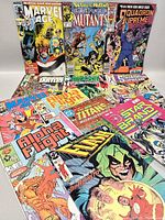 Photo showing a mix of Marvel comic books featuring Marvel Age, The New Mutants, Squadron Supreme, Alpha Flight, and The Flash.