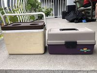 Photo showing the cooler and closed tackle box side by side