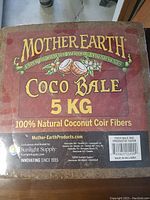 Photo showing front label on 5 KG bale of Mother Earth Coco Bale made of 100% natural coconut coir fibers.