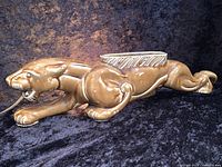 Side view of brown ceramic jaguar planter with light fixture and power cord, showing length and details on the body and face