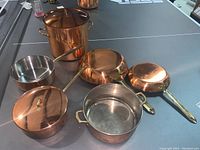 Top view of all copper cookware on table