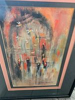Frontal view of the framed charcoal drawing showing colorful abstract figures and birds.