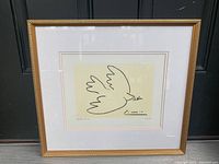 Full view of the framed Picasso "Dove of Peace" art print showing the gold-tone frame and matting surrounding the print.