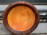 Top view of a round wooden bowl showing the parquet pattern with lighter wood in the center and darker wood in the rim.