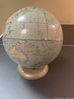 Full view of the vintage world globe showing the Pacific and surrounding regions with detailed country borders and place names.